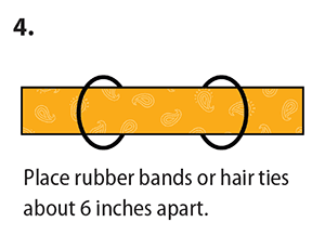 Place rubber bands or hair ties about 6 inches apart. 