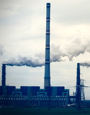 Factory spewing smoke into the air.