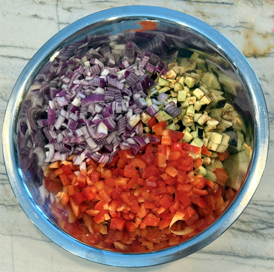 Prepare the bell peppers, eggplant and onion. Put them all into a large bowl.
