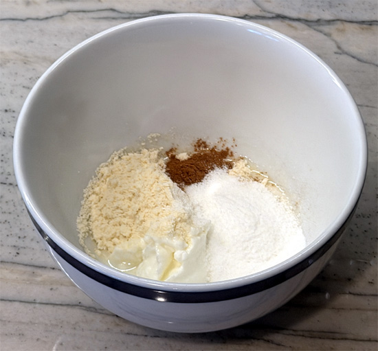 While the muffin bakes, stir together the yogurt, the remaining 2 tablespoons vanilla protein powder, 1 tablespoon fat-free milk, 1/4 teaspoon ground cinnamon, and monk fruit sweetener or zero-calorie sweetener in a small bowl until smooth.