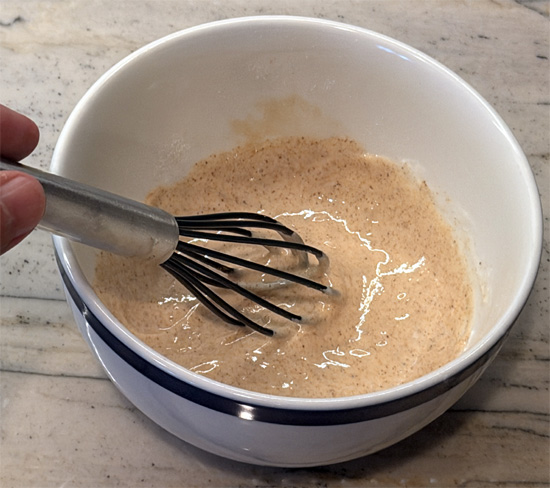 While the muffin bakes, stir together the yogurt, the remaining 2 tablespoons vanilla protein powder, 1 tablespoon fat-free milk, 1/4 teaspoon ground cinnamon, and monk fruit sweetener or zero-calorie sweetener in a small bowl until smooth.
