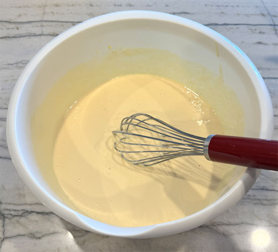 In a large bowl, whisk together the eggs, strawberry yogurt, and plain yogurt until smooth.