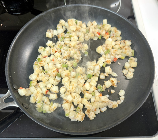 Add half the bag (about 3 cups) of Potatoes O'Brien in an even layer.