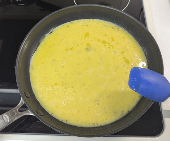 Pour in the eggs and cook, stirring constantly, for 5–6 minutes until scrambled and cooked through.