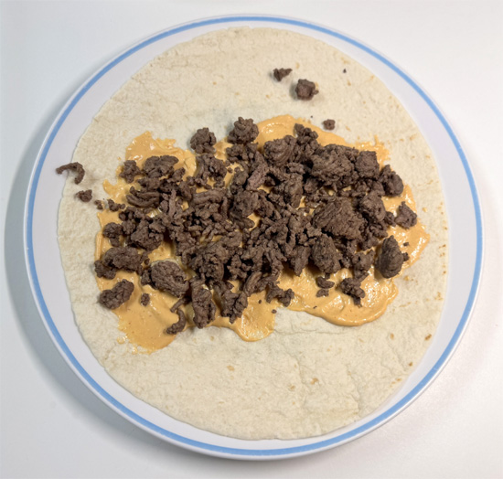 Evenly divide the beef (about 3/4 cup per burrito), potatoes (about 1/2 cup), and eggs (about 1/3 cup) among the tortillas.