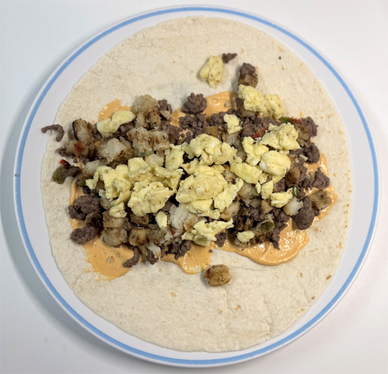 Evenly divide the beef (about 3/4 cup per burrito), potatoes (about 1/2 cup), and eggs (about 1/3 cup) among the tortillas.