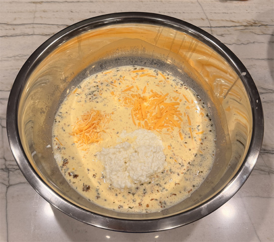 Stir cottage cheese into the egg mixture, then mix in both cheddar cheeses. 