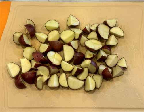 Prepare the potatoes, onion, mushrooms and bell peppers and set them aside. You can quarter the potatoes as shown in the picture, or chop them up finer if you want them to blend into the dish better. 