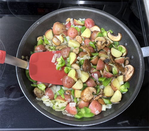Add the mushrooms and bell pepper to the potatoes and cook until the peppers are tender, about 5 minutes more. Stir regularly.