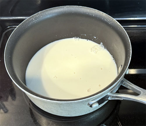 Put all the ingredients EXCEPT the syrup and peaches in a small saucepan. (Quinoa, almond milk, cinnamon sticks, vanilla extract and salt.) Bring to a high simmer, cover and reduce heat to low for 15 minutes.