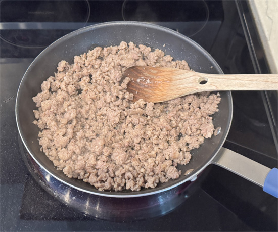 While crust bakes, cook sausage in a non-stick pan over medium-high heat for 5-7 minutes until lightly browned. Transfer sausage to the cheese mixture and stir to combine. Reserve the grease in the pan.