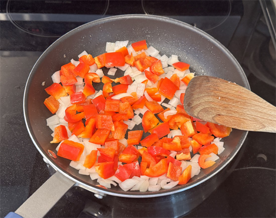 Using the same pan with reserved grease, cook onions for 3-4 minutes. Add bell peppers and cook 3-4 more minutes. Add mushrooms and cook final 2-3 minutes.