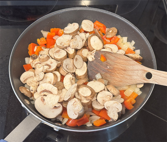 Using the same pan with reserved grease, cook onions for 3-4 minutes. Add bell peppers and cook 3-4 more minutes. Add mushrooms and cook final 2-3 minutes.