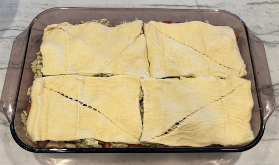 Unroll second tube of crescent rolls over the top. Bake 12-16 minutes until golden brown.