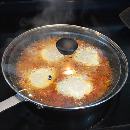 Shakshuka cooking covered.
