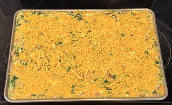 Pour everything into the prepared pan and sprinkle cheese over the top. Bake 18 to 22 minutes, until the center is set.
