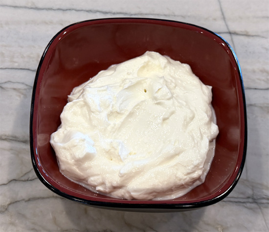 Place yogurt in a serving dish.