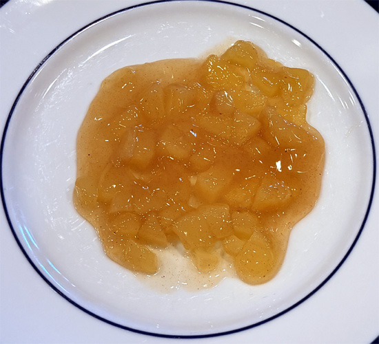 Cutting the apple pie filling up. 