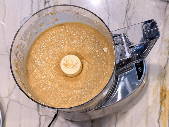 In a blender or food processor, combine the butter beans, Swerve Brown sugar, eggs, vanilla, oats, baking powder, baking soda, salt and 1/2 cup of the white chocolate chips. Blend until smooth, about 2 to 3 minutes, scraping down the sides once. 