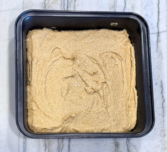 Pour the batter into the prepared pan and smooth the top. It will look thin, closer to pancake batter than brownie batter, and that's right.