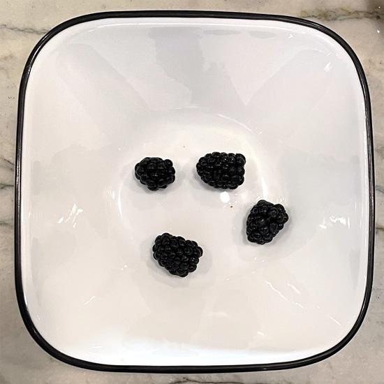 Put 4 blackberries in the bottom of every bowl.