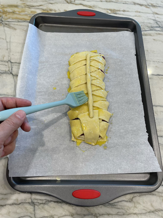 Whisk together the egg and use a brush to spread it across the pastry.