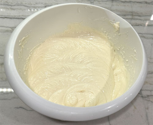 Slowly incorporate the following five ingredients: allulose sweetener, Jell-O, flour, lemon juice and vanilla extract. Keep mixing until it's smooth, about 2-4 minutes.