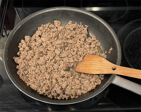 Set a large skillet over medium-high heat. Once hot, add the ground beef. Cook, stirring and breaking up with a spoon, until no longer pink, about 8 minutes.