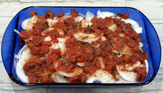 Evenly distribute the fire-roasted diced tomatoes over the onions.
