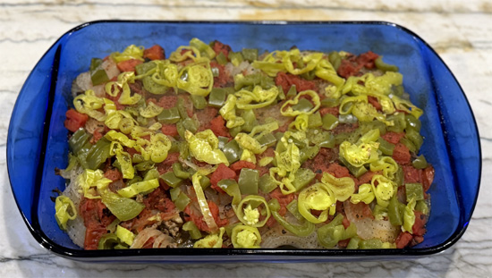 Cover the baking dish with foil. Bake in the preheated oven for 2 hours, or until the cauliflower is tender and the flavors have melded together.