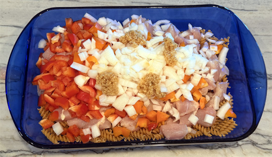 Mix together the pasta, chicken, bell peppers, onion, garlic, cream cheese, tomatoes, water, fajita seasoning. 