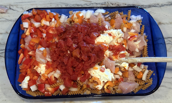 Mix together the pasta, chicken, bell peppers, onion, garlic, cream cheese, tomatoes, water, fajita seasoning. 