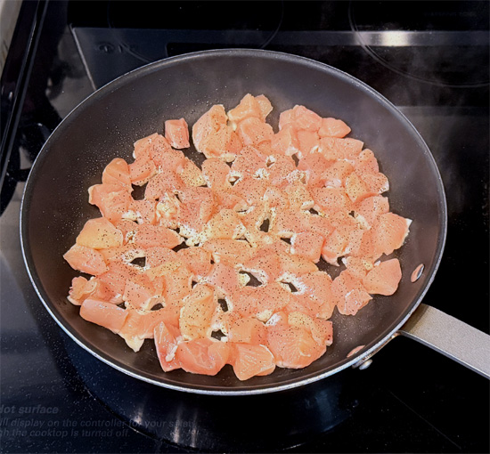 Spread the chicken in a single layer in the skillet, season it with 1/4 teaspoon black pepper and 1/4 teaspoon salt, and cook it undisturbed for about 2 minutes.