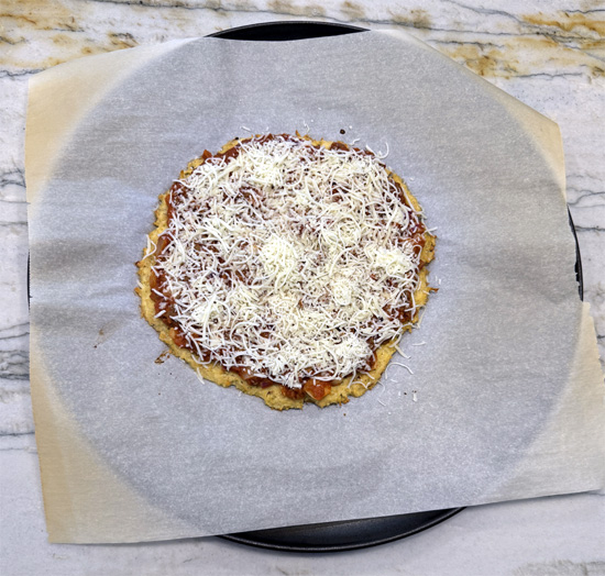 Spread the pasta sauce mixture over the pizza crust. Then sprinkle the mozzarella chese over the top. 