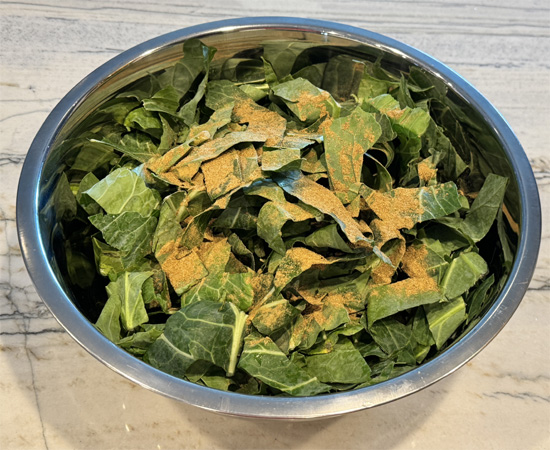 Prepare the Collard Greens: In a large bowl, toss the chopped collard greens with the cumin, sliced lemon, and lemon juice. Lightly spray with olive oil to coat.
