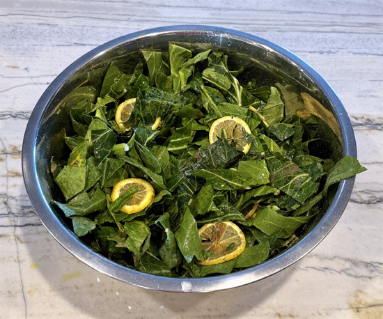 Prepare the Collard Greens: In a large bowl, toss the chopped collard greens with the cumin, sliced lemon, and lemon juice. Lightly spray with olive oil to coat.