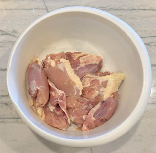 Place chicken in a bowl, season with one portion of the spice mix, covering all sides. For extra heat, add crushed red pepper.