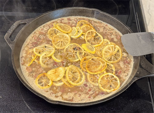 Assemble Dish: Nestle the seared chicken back into the pan, placing lemon slices on top. Cover with a lid or foil.