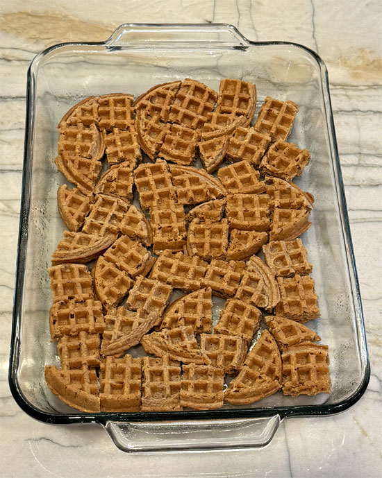 Arrange the waffles in a single layer at the bottom of the greased baking dish.