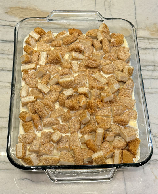 Pour the egg mixture over the waffles and Chick'n, then COVER with aluminum and let it stand for 15 minutes to soak before baking. 