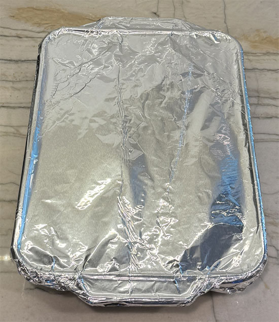 Pour the egg mixture over the waffles and Chick'n, then COVER with aluminum and let it stand for 15 minutes to soak before baking. 