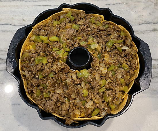 Spread half the ground beef mixture on top of the cheese.