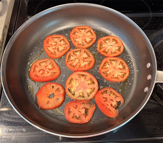 Sprinkle the salt over the oil, then layer the tomato slices and onion across the bottom of the pan. 