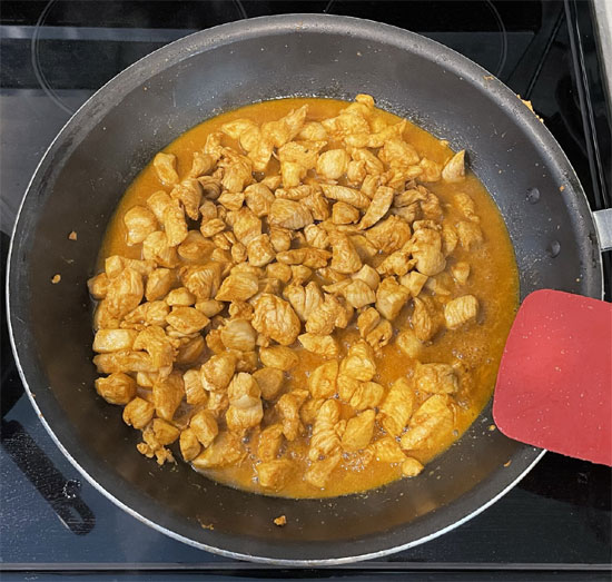 When the rice is cooked, heat a large pan over medium heat. Once it's hot, pour in the chicken and cook for 6 minutes.