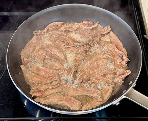Heat the olive oil in a large skillet over medium-high heat. Working in batches, add the steak strips in a single layer. Cook about 1–2 minutes per side, just until browned. Transfer the browned steak to your slow cooker.