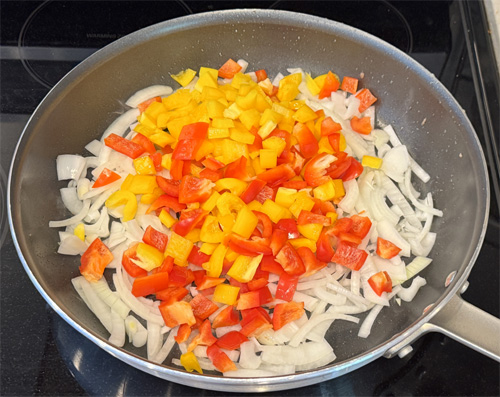 Use the same skillet and saute the bell peppers and onion. Cook for about 3-4 minutes until they soften, then add the minced garlic and cook for another 30 seconds. Pour all the ingredients into the slow cooker on top of the steak. 