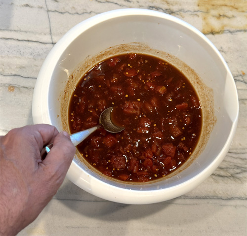 In a medium bowl, stir together the diced tomatoes (with juice), soy sauce, beef broth, brown sugar, Worcestershire sauce, ginger, black pepper, and crushed red pepper flakes (if using). Pour this mixture over the steak and veggies in the slow cooker. Stir gently to ensure everything is evenly coated.