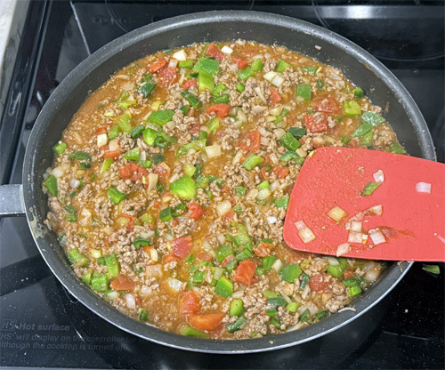 Stir in the beer, tomatoes, tomato paste, cumin, coriander, salt, black pepper, and Tabasco sauce and bring to a boil, about 2-3 more minutes.
