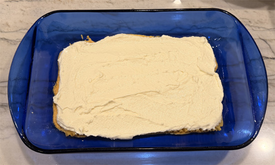 Dollop half of the ricotta mixture (about 2 cups) over noodles and spread gently to make an even layer. 