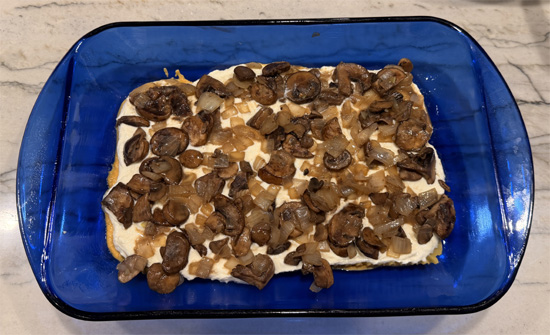 Spread half of the mushroom mixture over ricotta and sprinkle with 1 cup of the cheese mixture. 